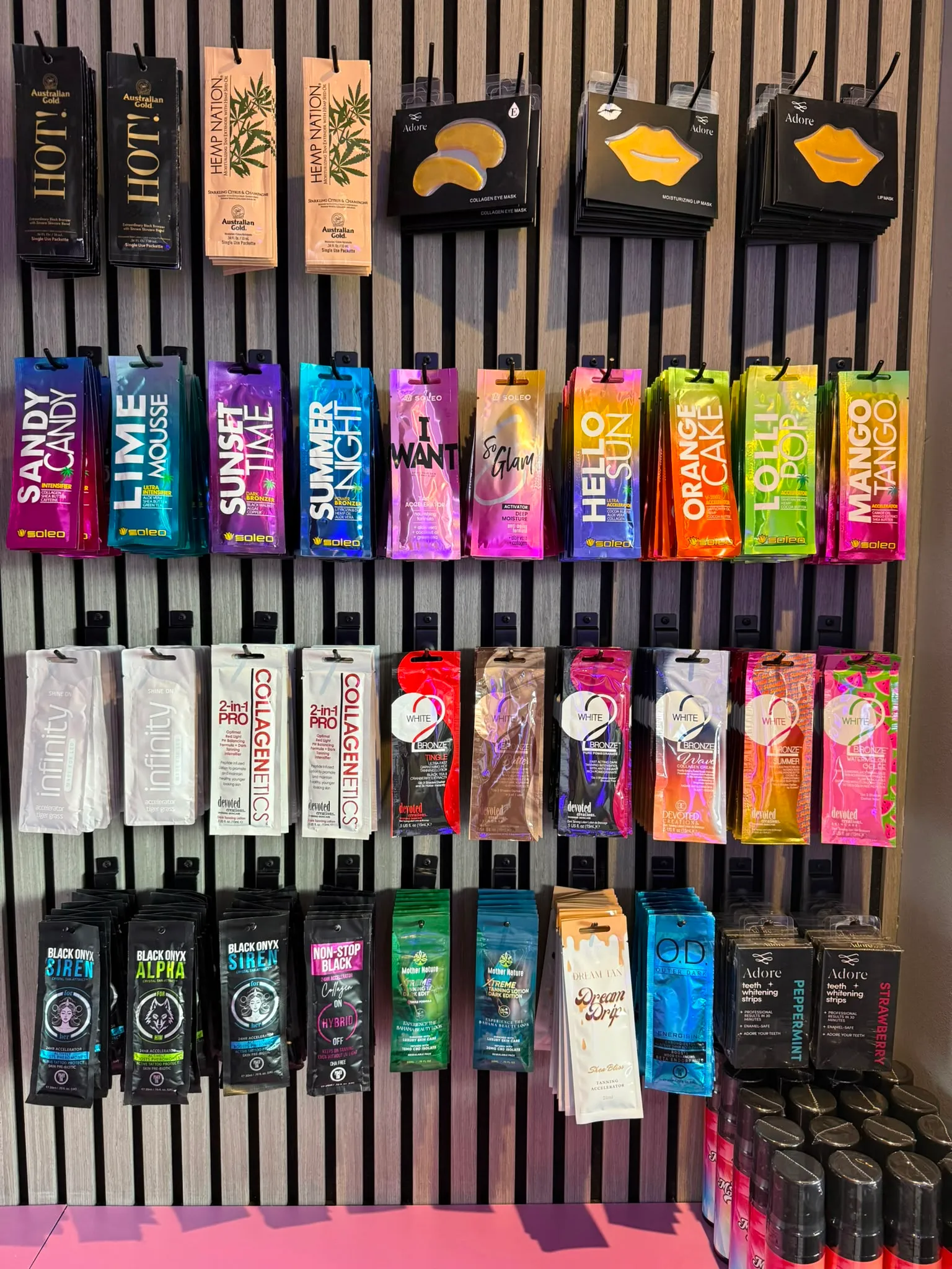Single-use tanning sachets and accelerators on the wall at Beautano, Nitshill Glasgow